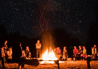 Group of people around a campfire